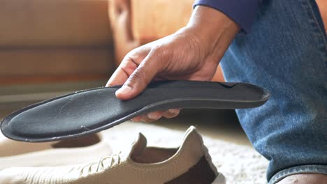 person examining or holding a shoe insole