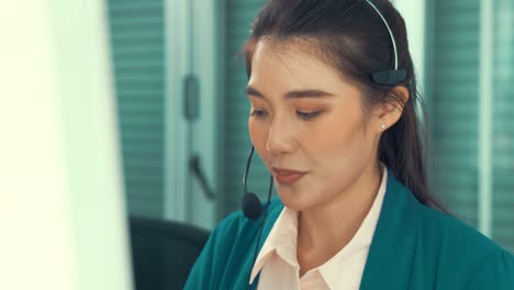 businesswoman wearing headset working actively in office