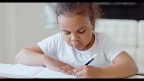 young girl writing in notebook