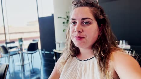 woman tasting white wine while filming a vlog