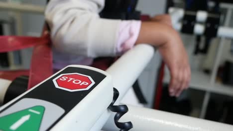 patient using mobility aid with stop button