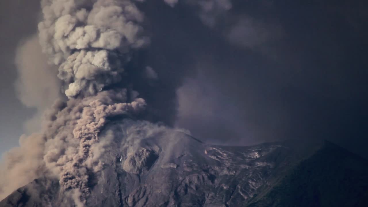 Fuego Volcano erupts heavily, shooting pyroclastic material into the sky and covering its surrounding area in ash