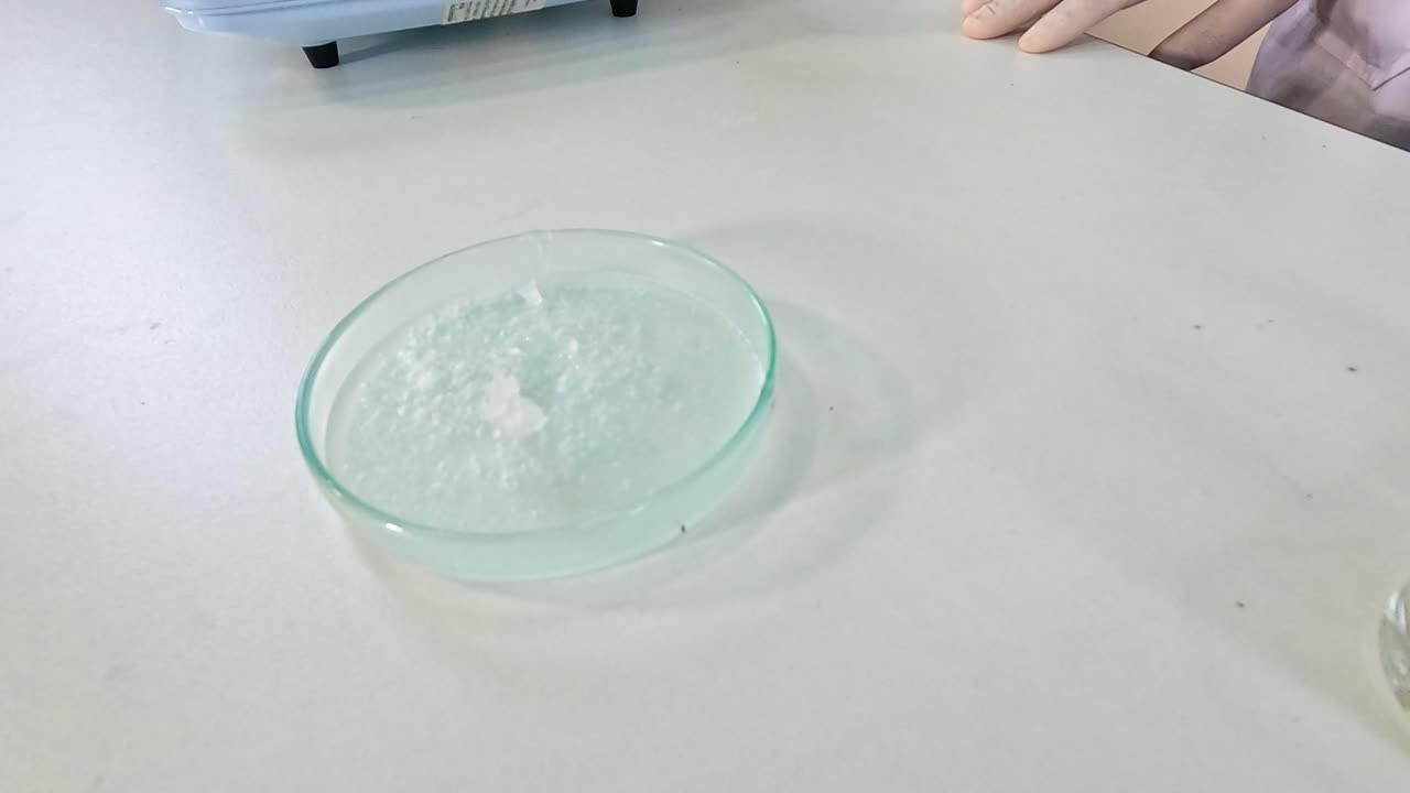 Sodium acetate crystallization in a petri dish, observed over 27 seconds with gradual crystal formation