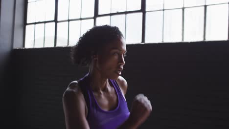 african american woman running with passion in an empty urban building