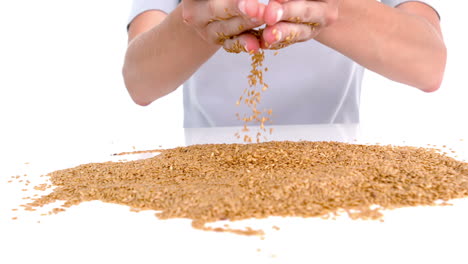 woman pouring grain on white background