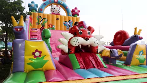 children playing on vibrant inflatable slide structure