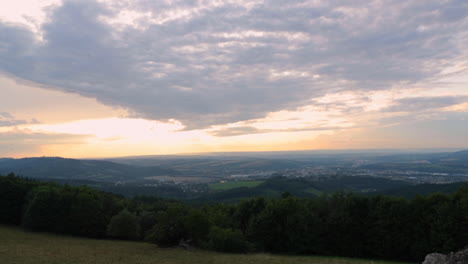 Timelapse-of-fast-moving-clouds-and-sun-going-down-during-sunset-day-to-late-time-captured-in-Czech-Republic-Europe-view-on-city-Valasske-Mezirici-from-view-point