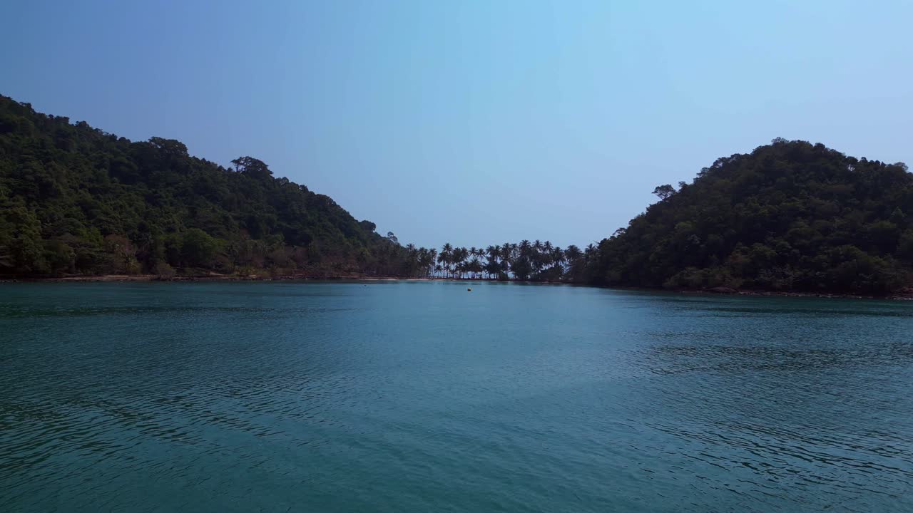 Scenic aerial view of lush green hills and turquoise waters on Koh Chang Ngam Island. Perfect aerial view flight fly reverse drone