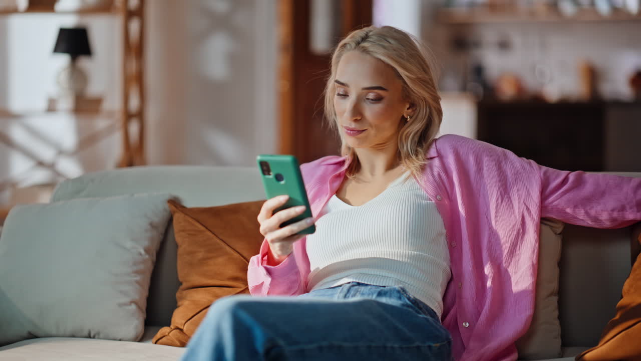 Overworked woman falling couch at living room. Relaxed girl using smartphone