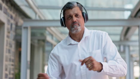 Dancing,-headphones-and-senior-businessman