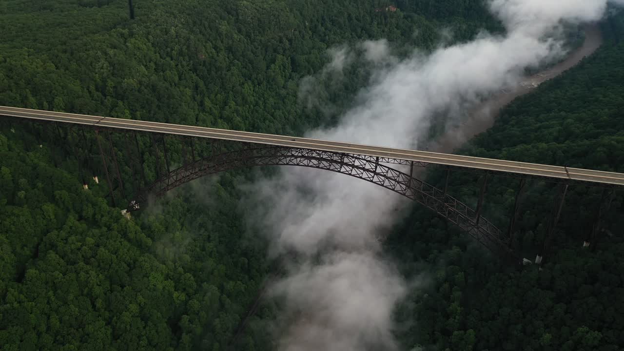 Aerial View of Bridge Above Clouds and New River Gorge Canyon, West Virginia USA. Light Freeway Traffic on Interstate Route-19