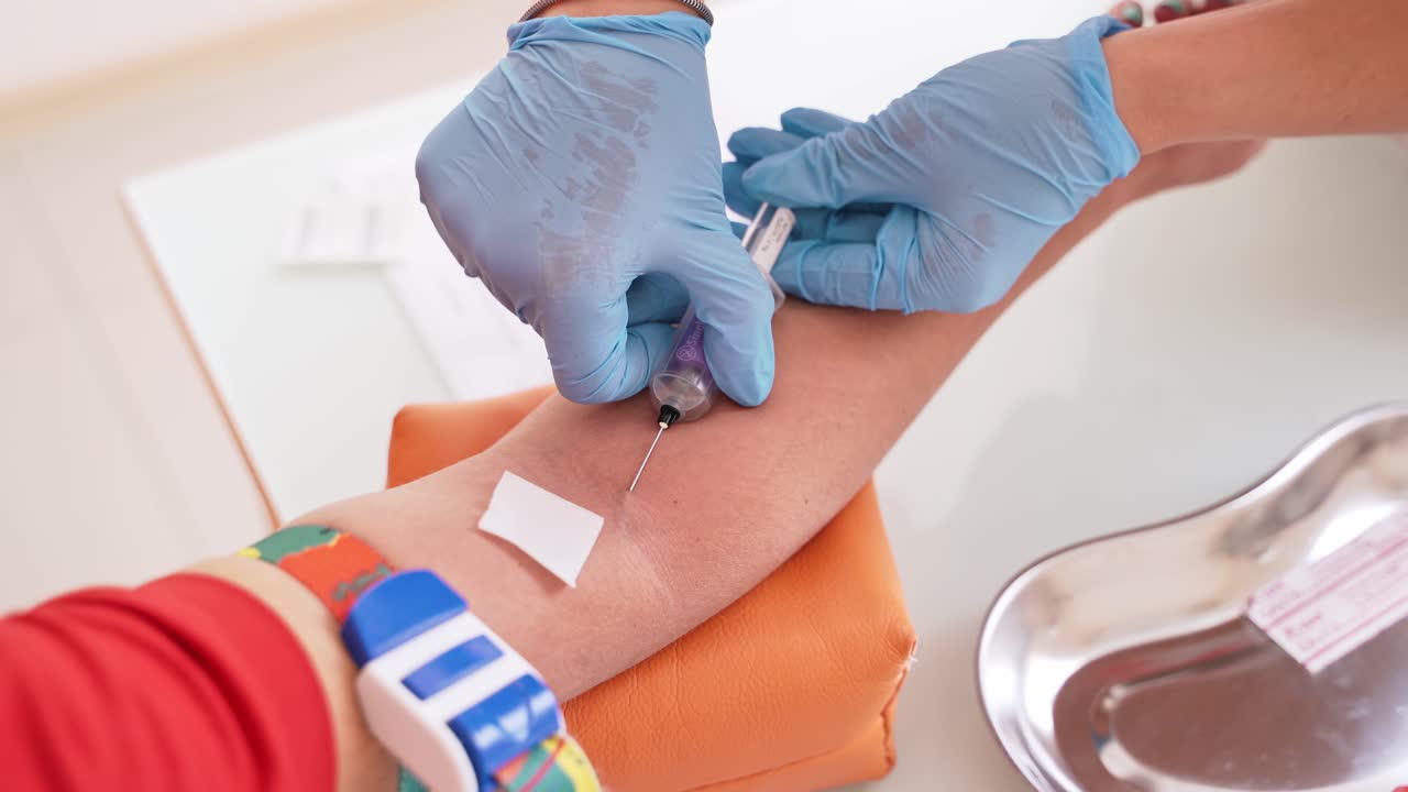 Patient during blood collection. Nurse taking blood sample for test in laboratory