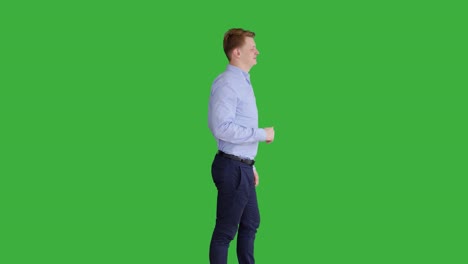 young handsome men acting in front of a green screen. blond hair, blue shirt and blue trousers. dancing, thinking, turning around and talking to the camera.