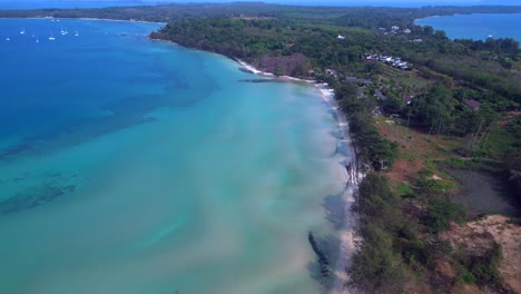 koh mak tropical beach meeting turquoise water under blue sky in thailand. nice aerial view flight tilt down drone