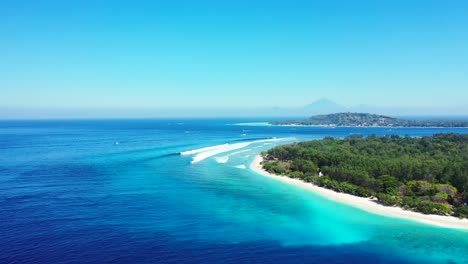 colorful seascape with green vegetation of tropical island surrounded by white sand of exotic beach and blue azure sea in indonesia