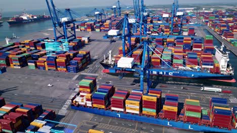 Aerial view of a bustling port with colorful shipping containers and cranes, capturing the dynamic