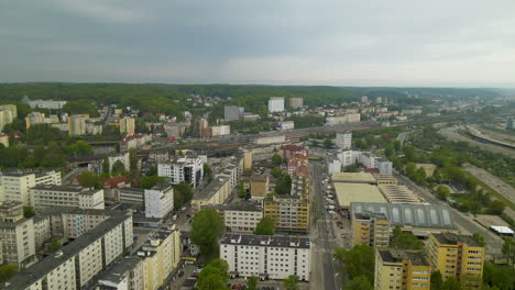 Slow-aerial-pull-back-over-buildings-rooftops-of-Grynia-residential-district,-daytime