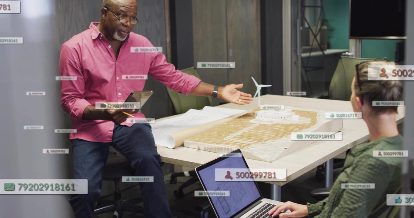 Senior lead presenting turbine model in design while woman typing, column moving labels popping