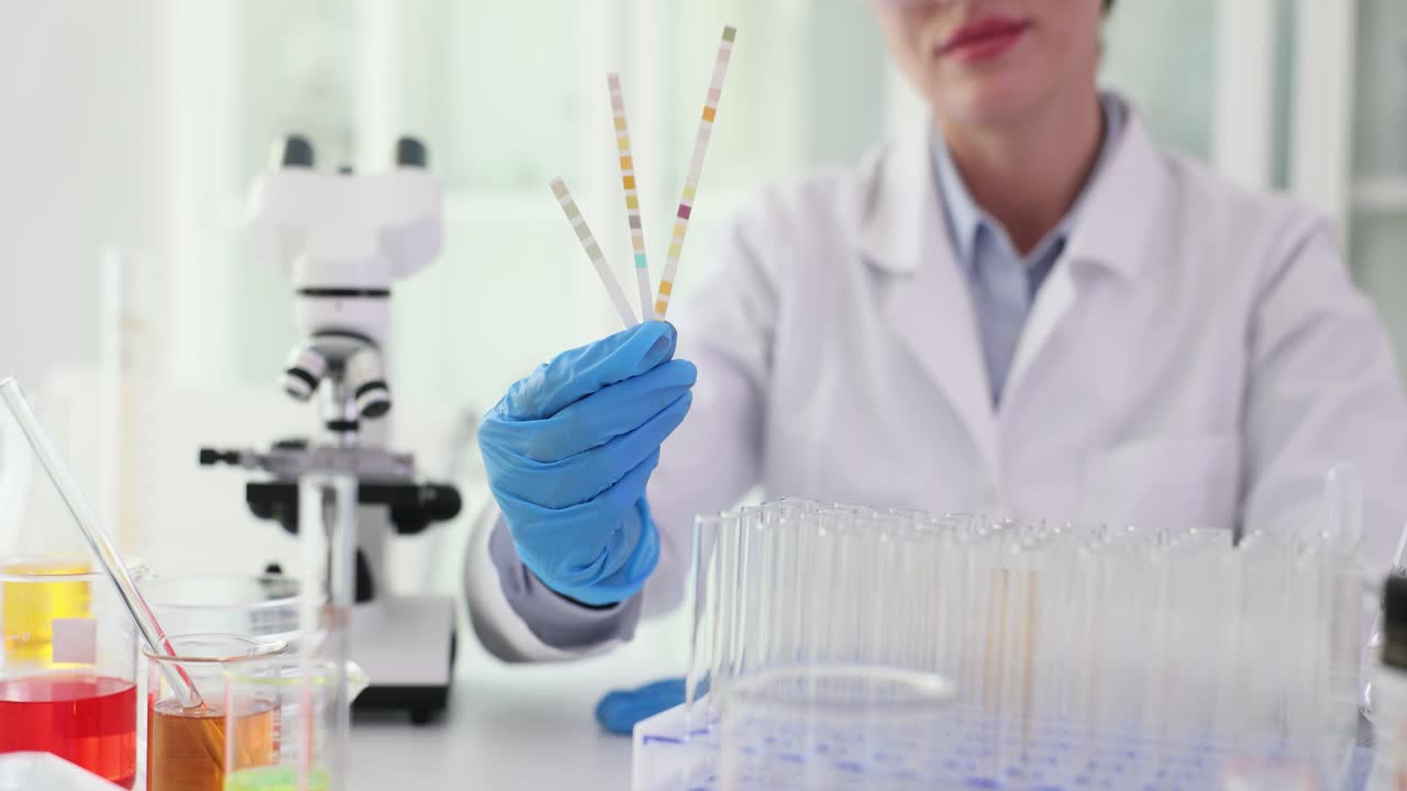 Scientist in Lab Examining Urine Strips
