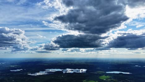 drone hyperlapse of skyline under moody skies showing motion and expansive natural light rays with cloud reflections in water