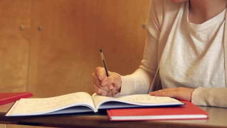 student taking down notes in class