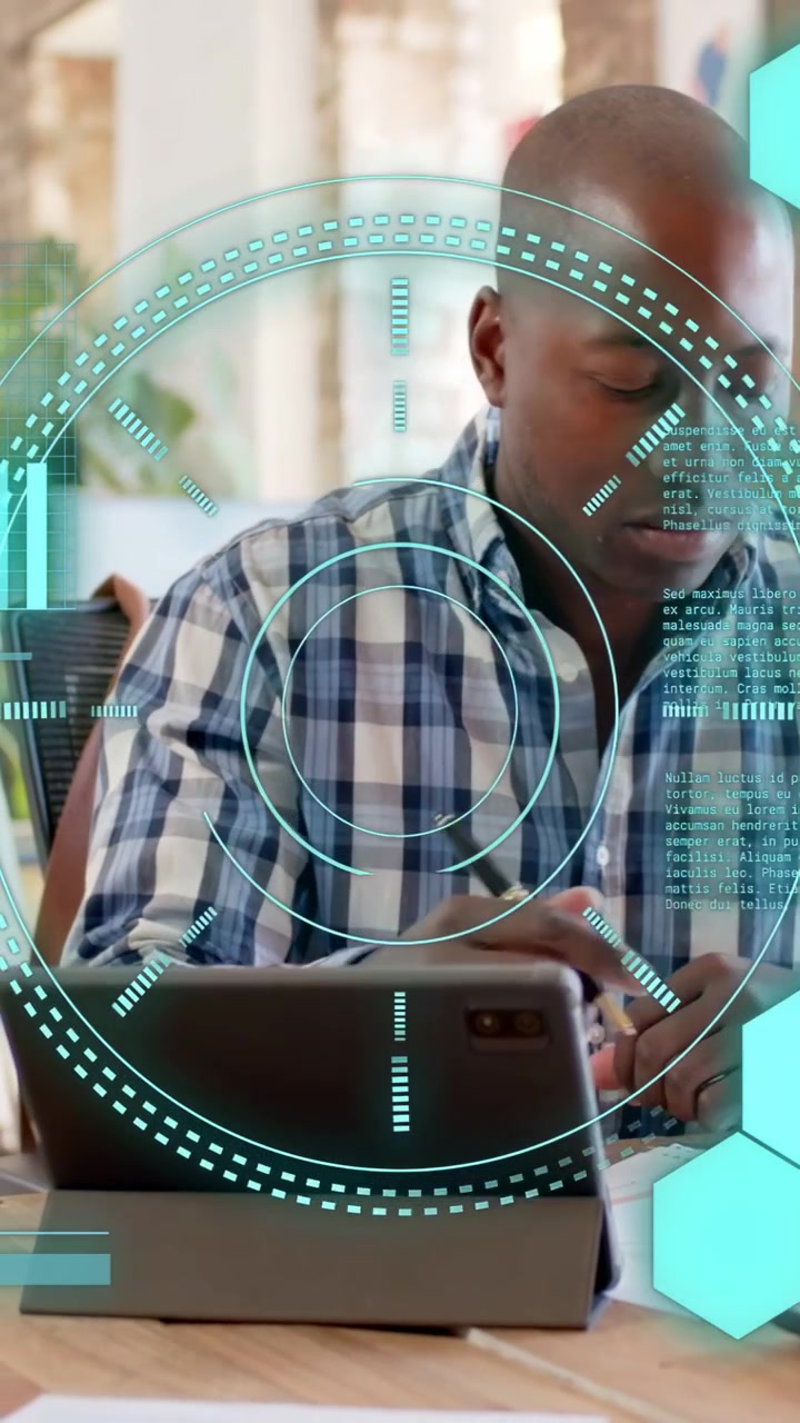 Vertical video: Man tapping tablet, activating teal HUD, writing tech notes while glancing right