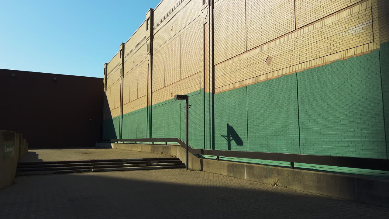 Golden Hour Light Casts Long Shadows Across a Quiet Corner of Downtown Hamilton, Ontario, Canada - Orbit Drone Shot
