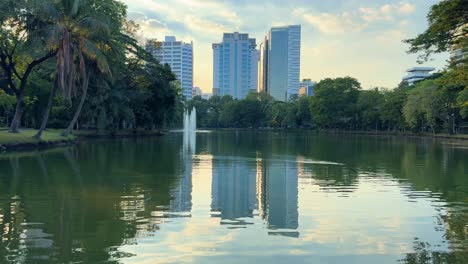 Modern-building-reflexion-in-lake-water-Lumpini-Park-Bangkok-Thailand