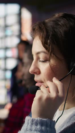 vertical video customer support workers listening to clients problems using headphones