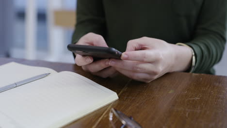 a woman using her cellphone while sitting