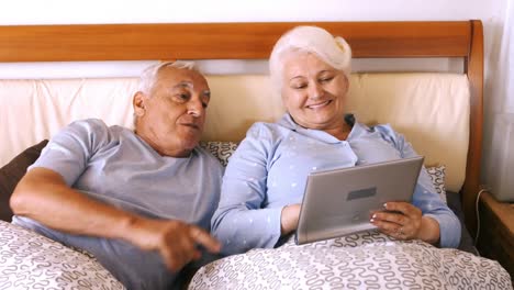 senior couple using digital tablet