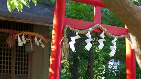 japanese torii gate with shimenawa and shrine building