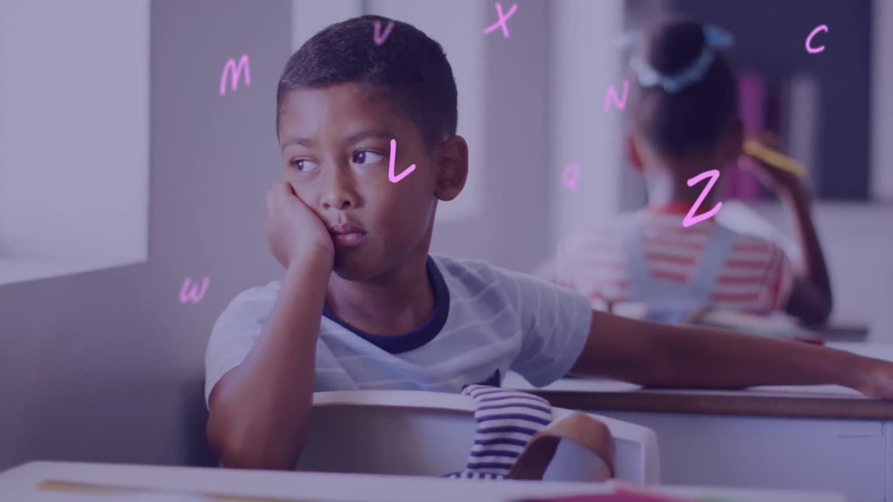 Animation of letters over bored biracial schoolboy at desk in classroom