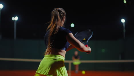 woman playing tennis at night