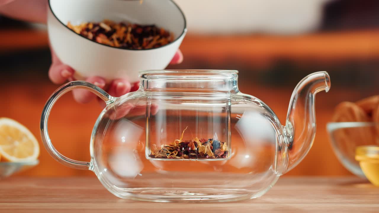 Preparing Herbal Tea in a Glass Teapot