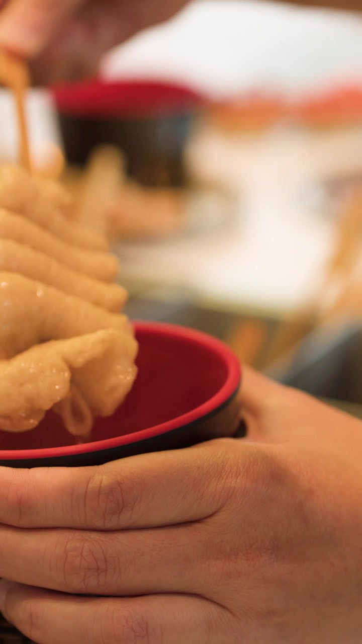 Chef Pouring Hot Broth into Bowl with Fish Cake Skewer