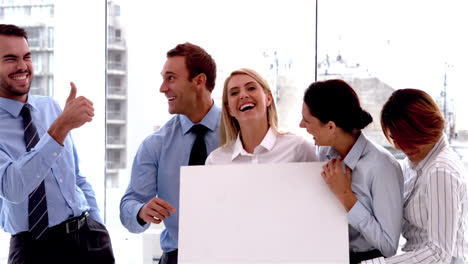 team of business people laughing together with card