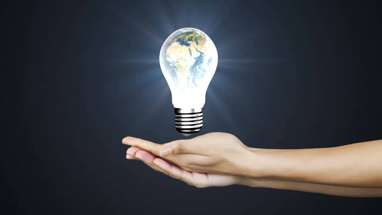 Holding glowing light bulb with Earth inside, hand creating animation concept