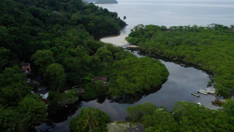 Aerial-view-tilting-over-the-Rio-Sahy-river,-towards-the-sea-at-Sao-Sebastiao,-Brazil