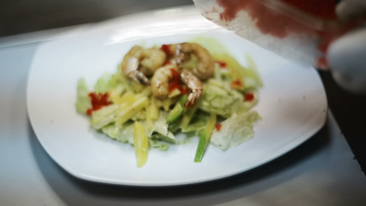 Chef Preparing Food. Seafood salad with prawns on commercial kitchen