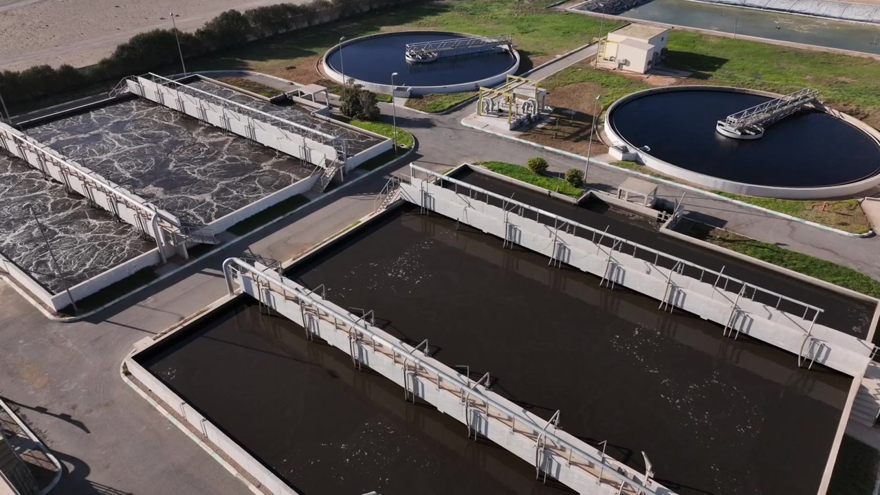 Close aerial drone view of industrial water treatment tanks and engineering infrastructure in Dakhla Morocco ideal for environmental and industrial projects