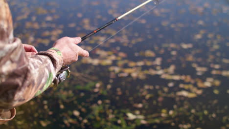 Man-reeling-in-spinner-fishing-rod