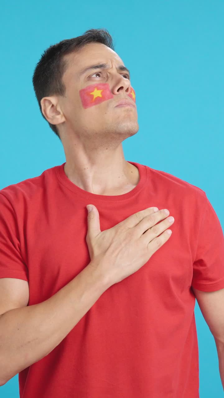 Man listening to the Vietnam national anthem with solemnity