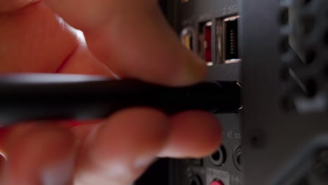 Man attaching a Wi-Fi antenna to a PC
