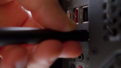 man attaching a wi-fi antenna to a pc