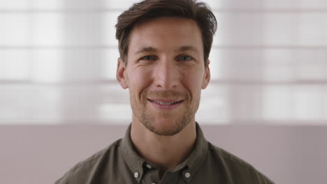 close up portrait of attractive young man smiling happy looking at camera