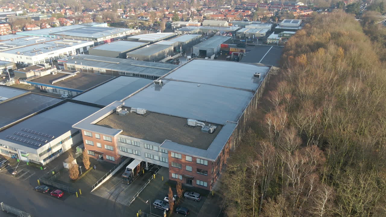 High jib up of solar panels on industrial building near forest