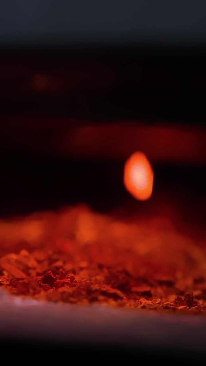 Close Up of Glowing Red Embers in a Dark Setting