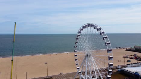 amusement park with ferris wheel and sea beach in great yarmouth, norfolk, england - aerial drone shot