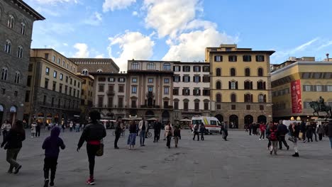 people walking in a bustling city square